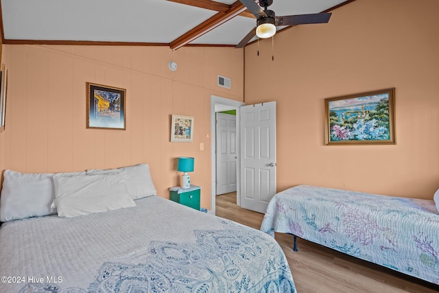 bedroom with vaulted ceiling with beams, ceiling fan, and light wood-type flooring