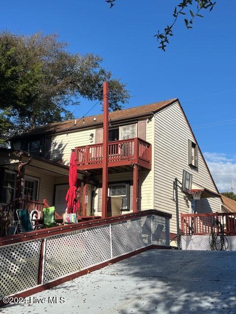 rear view of property featuring a balcony