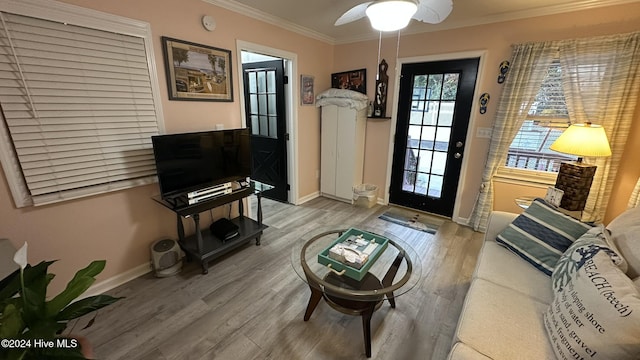 interior space featuring hardwood / wood-style floors, ceiling fan, and crown molding