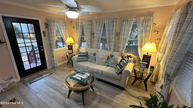 living room featuring crown molding, hardwood / wood-style floors, and ceiling fan