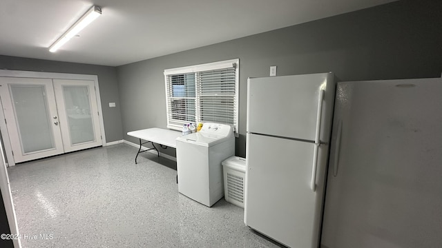 kitchen featuring washer / clothes dryer and white fridge