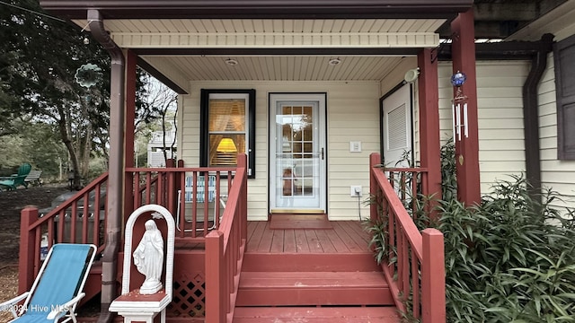 view of exterior entry with covered porch