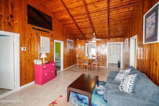 tiled living room with wooden ceiling, ceiling fan, lofted ceiling with beams, and wood walls