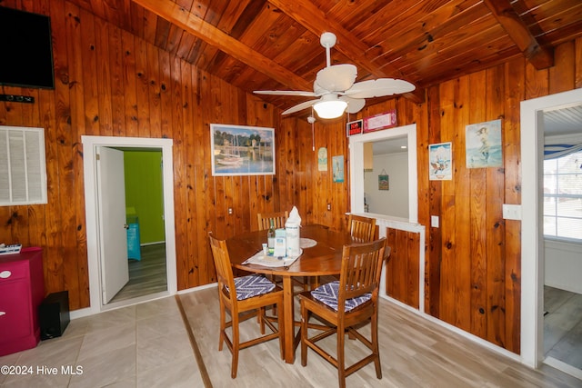 tiled dining area with beam ceiling, ceiling fan, and wooden ceiling