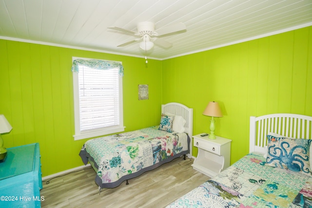 bedroom featuring ceiling fan, ornamental molding, wood ceiling, and light hardwood / wood-style flooring