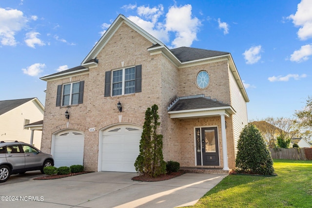 view of front property featuring a garage and a front yard