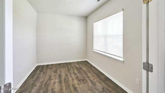 unfurnished room featuring dark hardwood / wood-style flooring and plenty of natural light