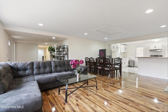 living room featuring sink and light hardwood / wood-style floors