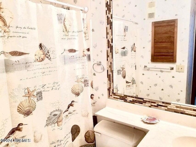 bathroom with a shower with curtain, vanity, and toilet