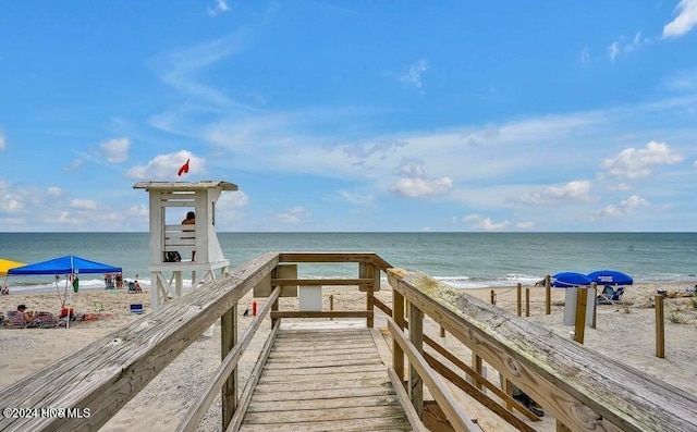 view of home's community with a beach view and a water view