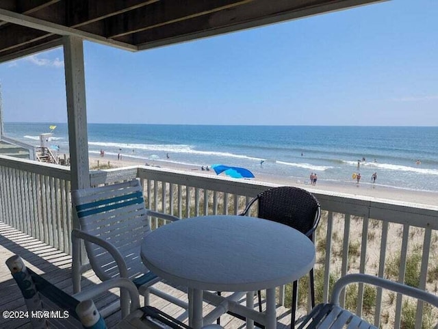 balcony with a water view and a beach view