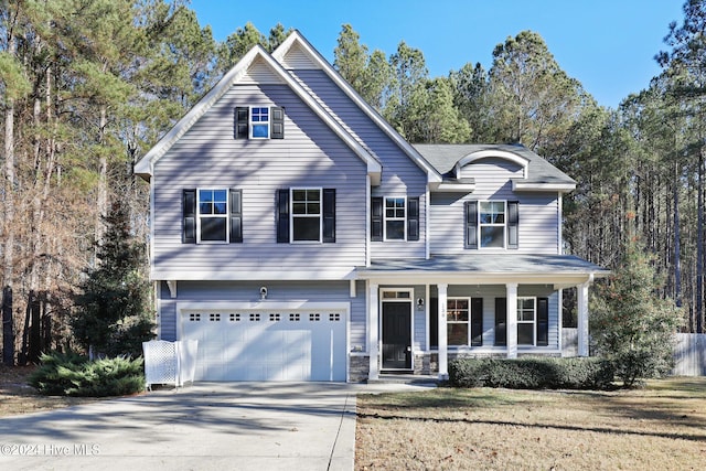 view of front property featuring covered porch and a garage