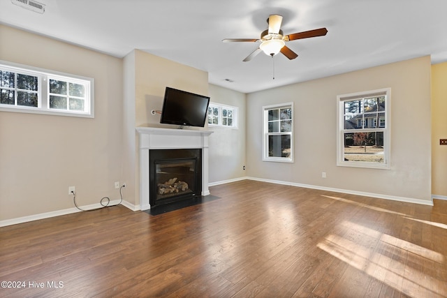 unfurnished living room featuring ceiling fan and dark hardwood / wood-style floors