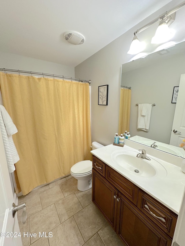 bathroom featuring tile patterned floors, vanity, and toilet