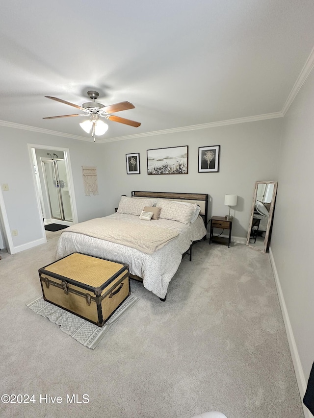 bedroom with carpet floors, ceiling fan, ornamental molding, and connected bathroom