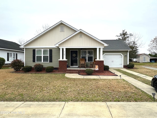 craftsman-style home featuring a front lawn, a porch, and a garage