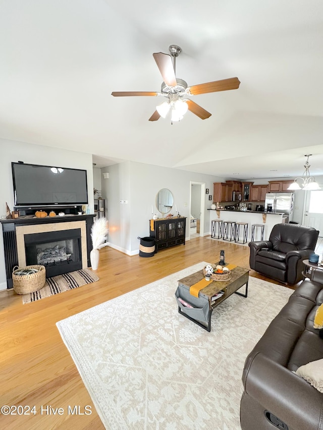 living room with light hardwood / wood-style flooring and ceiling fan