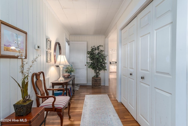 hall with crown molding and hardwood / wood-style flooring