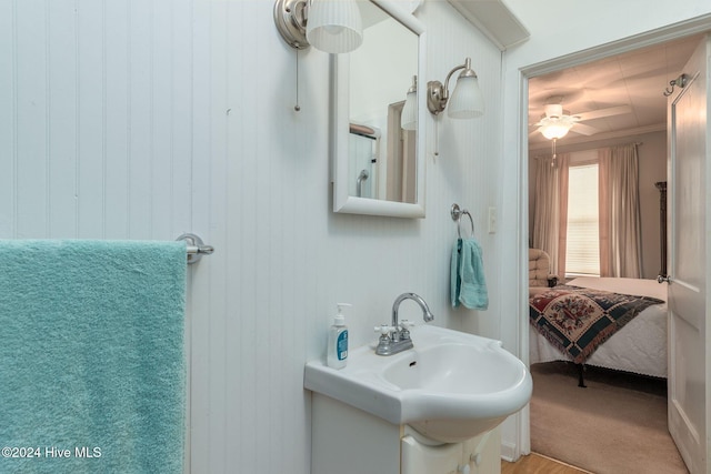 bathroom featuring ceiling fan, sink, and ornamental molding