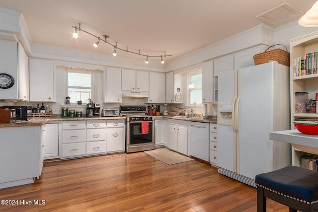 kitchen featuring decorative backsplash, white appliances, stone countertops, light hardwood / wood-style floors, and white cabinetry