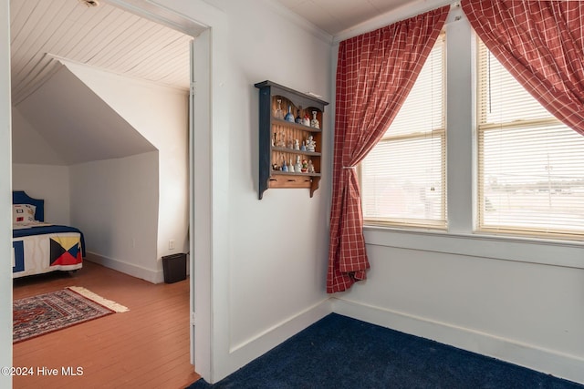 bedroom with crown molding and vaulted ceiling