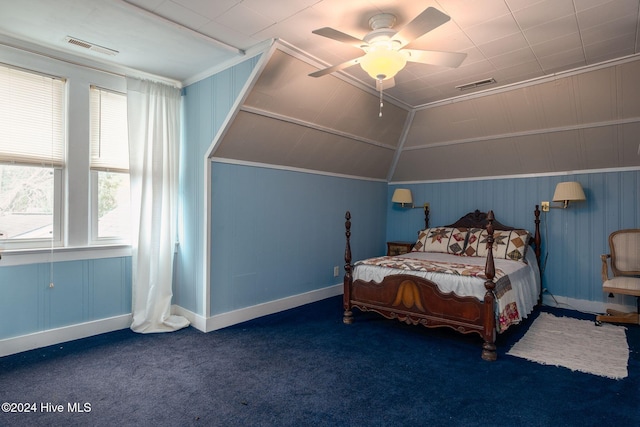 bedroom featuring dark colored carpet, ceiling fan, ornamental molding, and multiple windows