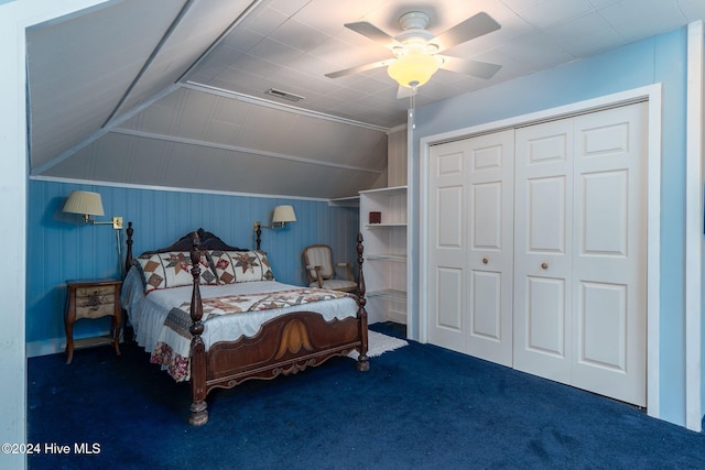 bedroom with dark colored carpet, a closet, vaulted ceiling, and ceiling fan