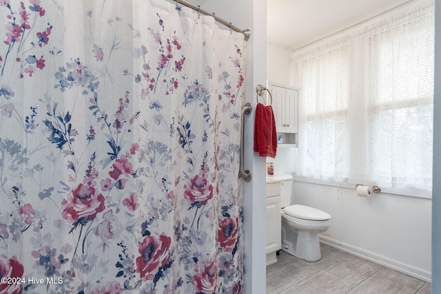 bathroom featuring vanity, toilet, and walk in shower