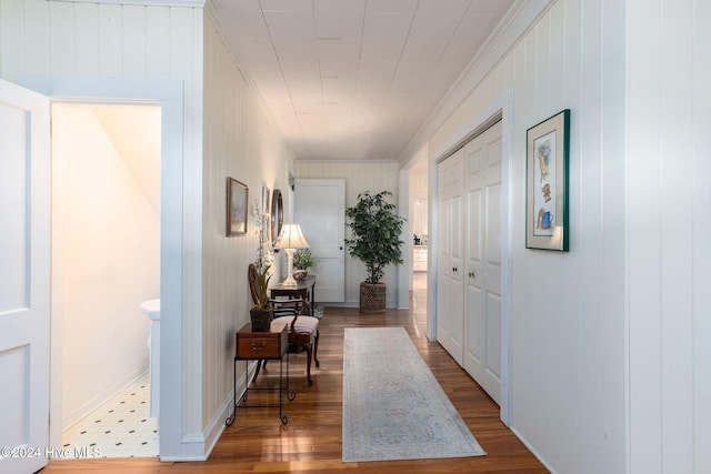 hall featuring wood-type flooring and crown molding