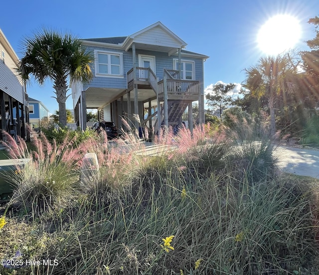 coastal inspired home with a carport and a porch