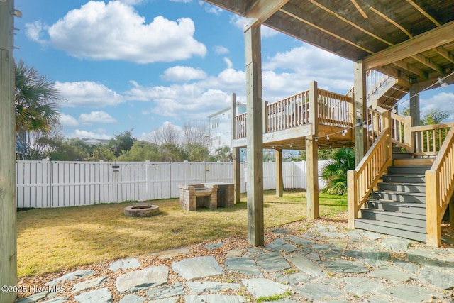 view of patio with a wooden deck and an outdoor fire pit