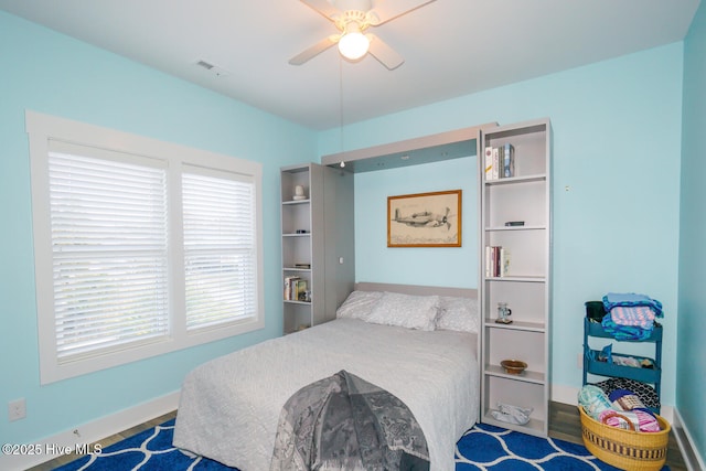 bedroom featuring multiple windows and ceiling fan