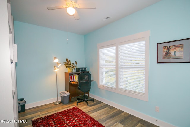 living area featuring dark hardwood / wood-style flooring, a wealth of natural light, and ceiling fan