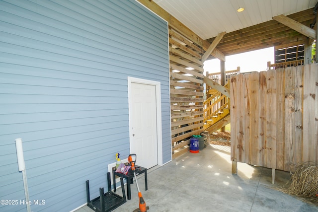 view of side of property with a patio area and stairway