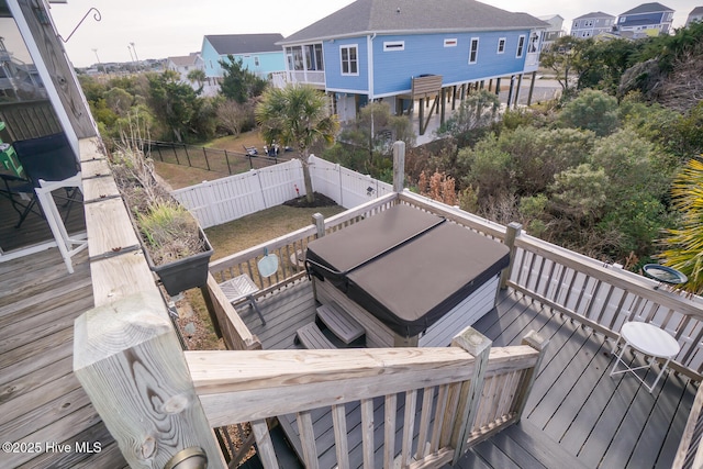 wooden deck with fence and a hot tub