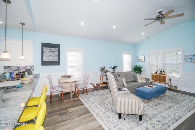 living room featuring ceiling fan, lofted ceiling, and hardwood / wood-style flooring