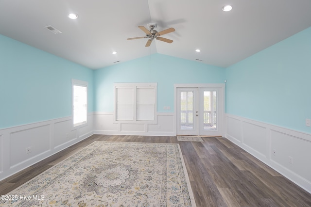 spare room with vaulted ceiling, a ceiling fan, wainscoting, french doors, and visible vents