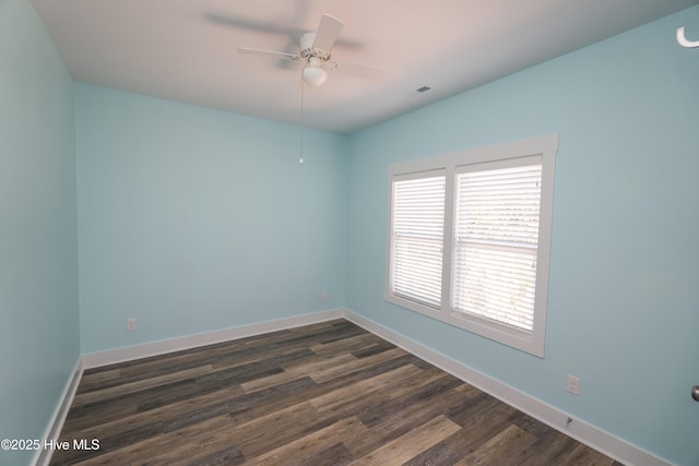 unfurnished room featuring ceiling fan, baseboards, dark wood-type flooring, and visible vents