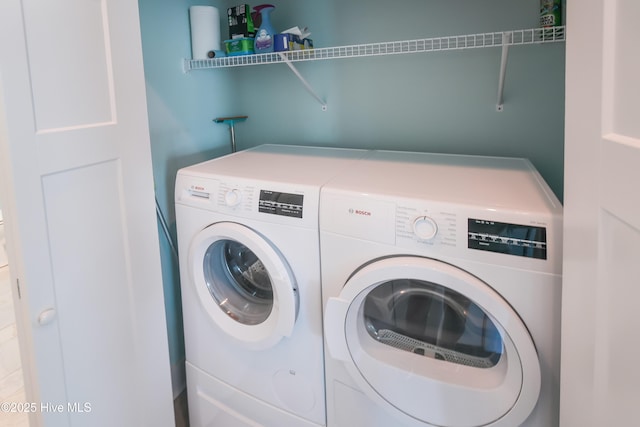 washroom featuring washer and dryer and laundry area