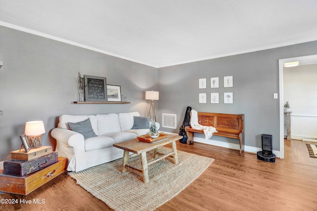 living room featuring crown molding and wood-type flooring