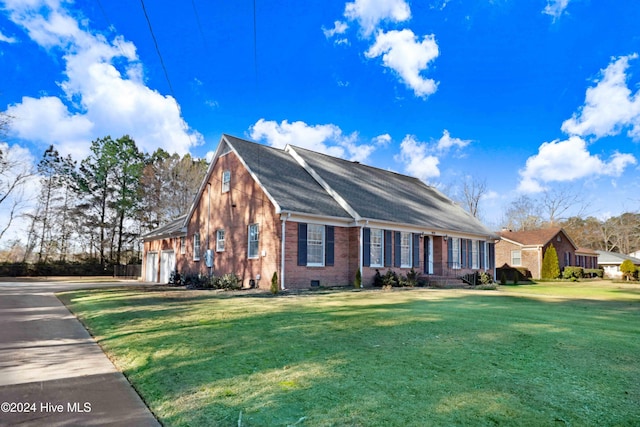 view of front of house featuring a garage and a front lawn