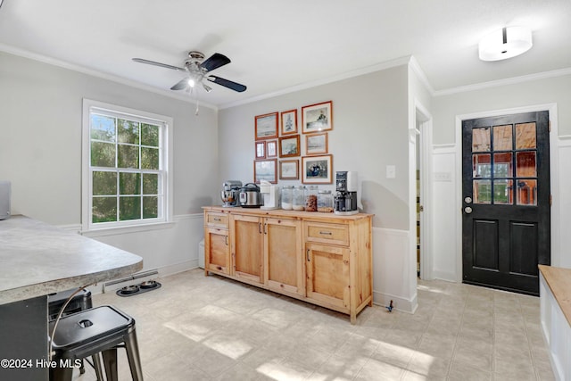 kitchen featuring ceiling fan and ornamental molding