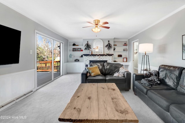 living room featuring built in shelves, ceiling fan, a baseboard radiator, crown molding, and light carpet