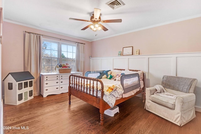 bedroom with ceiling fan, wood-type flooring, and ornamental molding