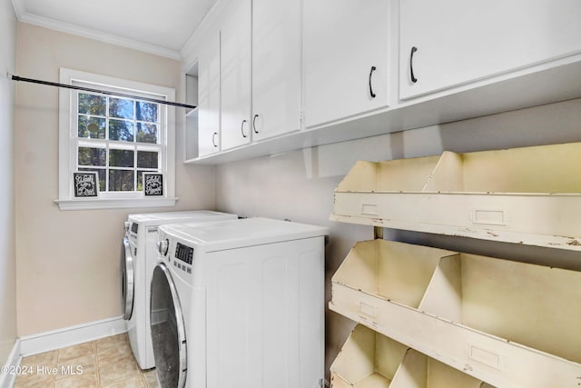 clothes washing area featuring cabinets, washer and dryer, crown molding, and light tile patterned flooring