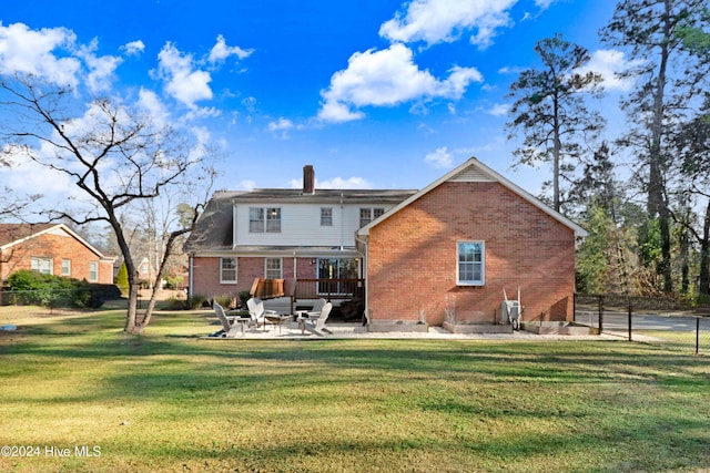 back of property featuring a patio and a lawn