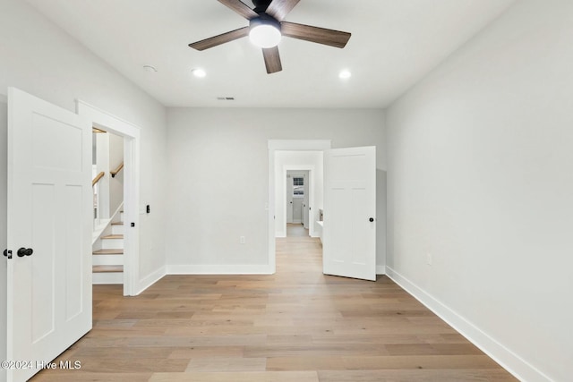 empty room featuring ceiling fan and light hardwood / wood-style floors