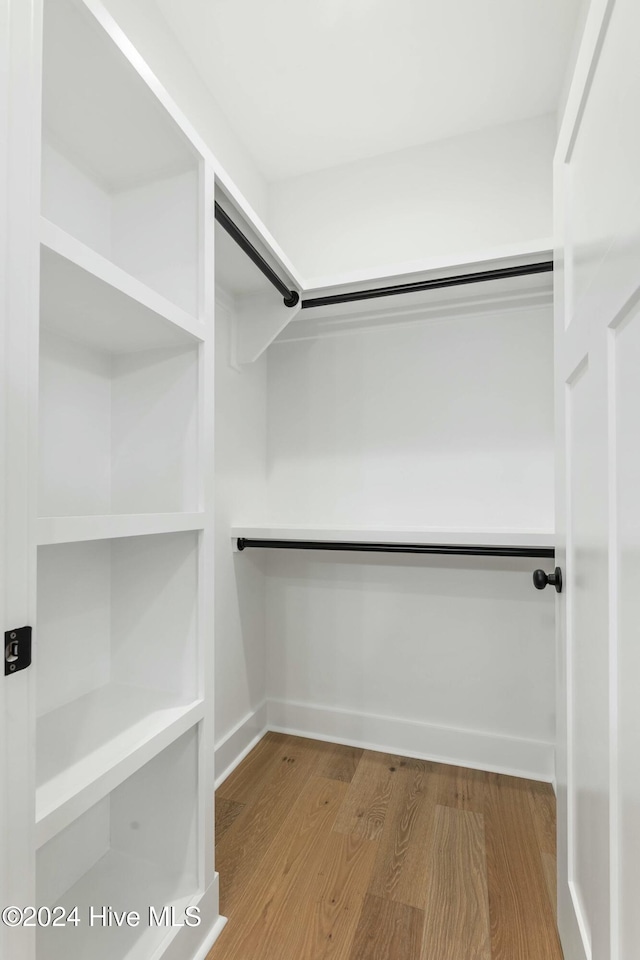 spacious closet featuring hardwood / wood-style floors