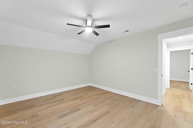 additional living space with ceiling fan, light hardwood / wood-style flooring, and vaulted ceiling