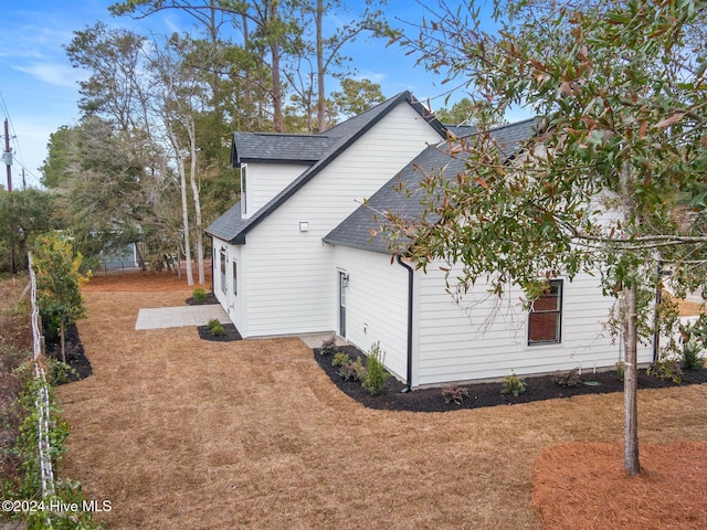 view of property exterior with a yard